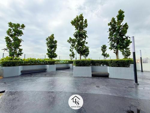 a park with a row of trees and bushes at Nexus Kajang MRT link - 3 BR Cozy Muji Suite # 28 in Kajang