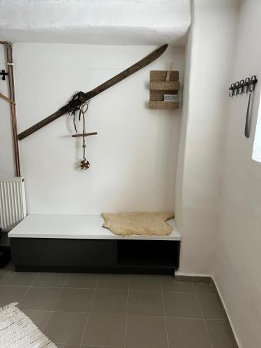 a room with a bench with a cross on the wall at Apartman 825 in Jáchymov