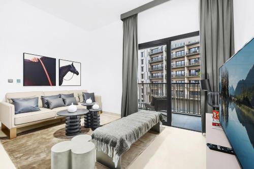 a living room with a couch and a table at Luxury 1BR City View with Balcony Parking & WiFi Near Dining & Downtown in Dubai