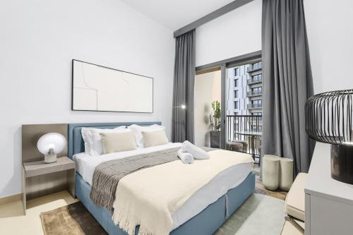 a bedroom with a blue bed and a balcony at Luxury 1BR City View with Balcony Parking & WiFi Near Dining & Downtown in Dubai