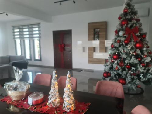 a christmas tree in a living room with a table and chairs at Eva Luxury Villa in Lachi