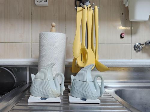 three kitchen utensils on a counter in a kitchen at UngsungKo Land # Family trip # Soongsil University # Chung-Ang University # Sangdo Station # OTT in Seoul