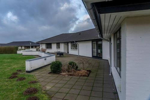 a house with a patio in front of it at Villa Teglgårdshaven in Sindal