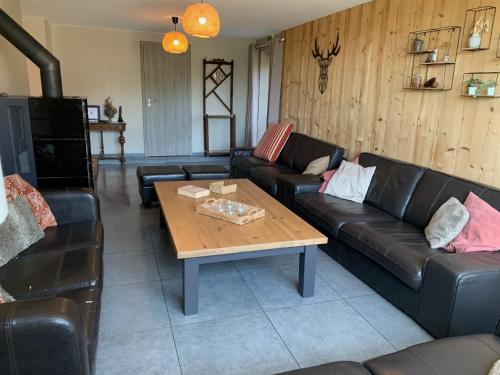 a living room with a couch and a coffee table at Coeur de Boeur in Houffalize