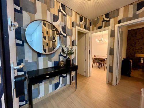 a bathroom with a mirror on a wall at Cozy Apartment Almada in Almada