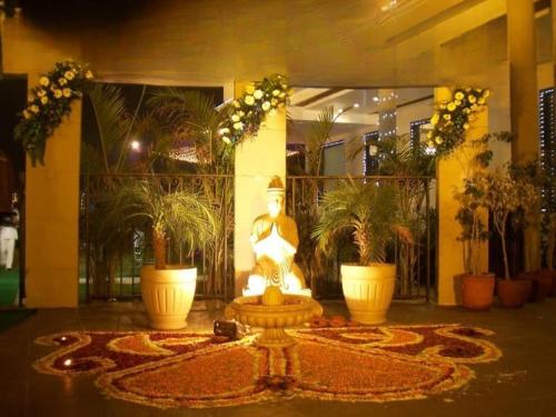 a fountain in a lobby with potted plants at Dreamanor Blissful Stay Amritsar in Amritsar