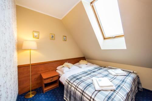 a bedroom with a bed and a skylight at Pensjonat Pod Tatrami in Szaflary