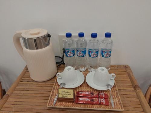 a coffee table with bottles of water and a blender at Tâm Homestay in Hue