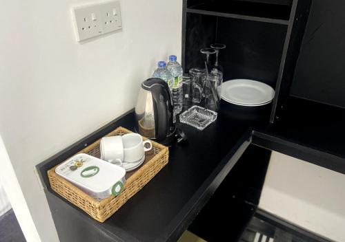 a kitchen counter with a tray with a coffee maker at Paraiso Guest House in Ella