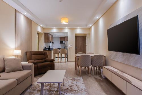 a living room with a large flat screen tv at Second Home Hospitality, Rehab City, New Cairo, Cairo Egypt in New cairo