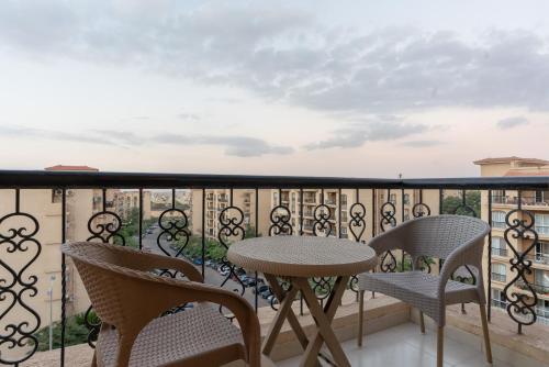 a balcony with a table and chairs and a view at Second Home Hospitality, Rehab City, New Cairo, Cairo Egypt in New cairo