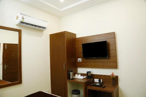 a room with a flat screen tv on a wall at Hotel Bahl Regency in Zirakpur