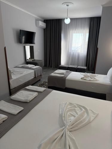 a hotel room with two beds and a couch at --HOTEL DEAL-- Rooms With Castle View in Krujë