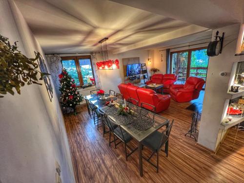 a living room with a christmas tree and a table and chairs at Dom na wzgórzu - Brenna in Brenna