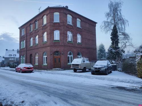 a red brick building with cars parked in front of it at Apartment 58- Ruhr Nah in Essen