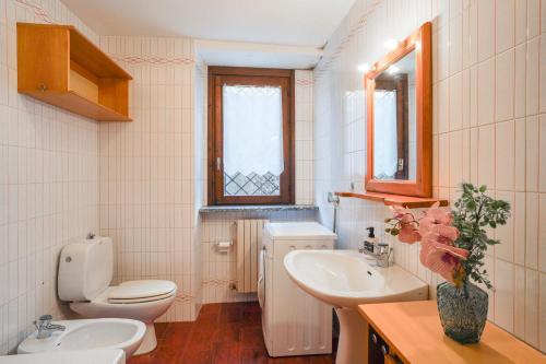 a bathroom with a toilet and a sink at La Corte Antica in Cassina Valsassina