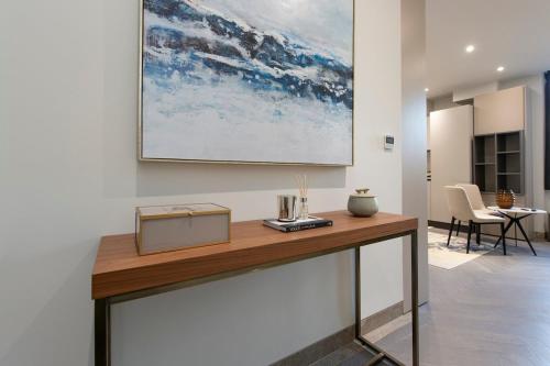 a table in a room with a painting on the wall at City Escape - Stylish Studio in Central Reading - CHRL F16 in Reading
