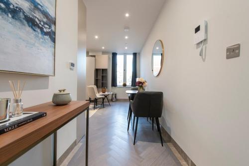 a kitchen and living room with a table and chairs at City Escape - Stylish Studio in Central Reading - CHRL F16 in Reading