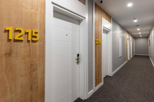 a hallway with a white door with a number on it at Days Inn & Suites by Wyndham Esenyurt in Istanbul