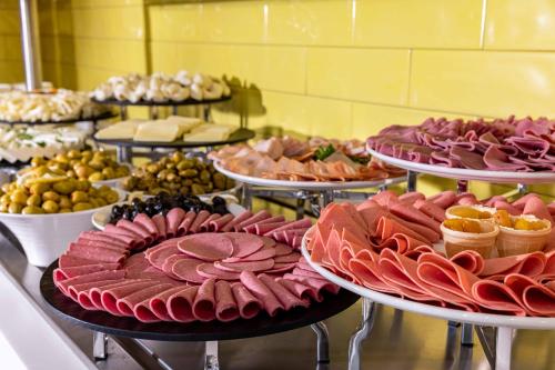 a buffet with many different types of food on plates at Days Inn & Suites by Wyndham Esenyurt in Istanbul
