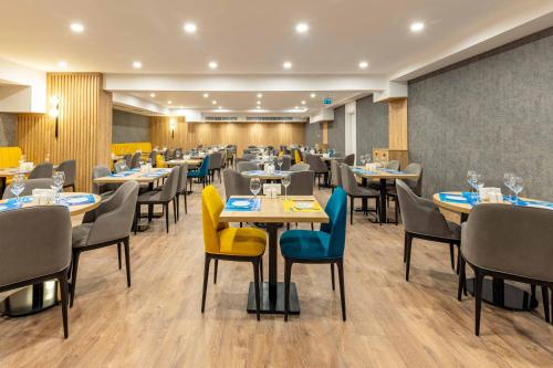a dining room with tables and chairs in a restaurant at Days Inn & Suites by Wyndham Esenyurt in Istanbul