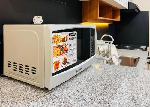 a microwave sitting on top of a kitchen counter at Avida Towers Atria in Iloilo City