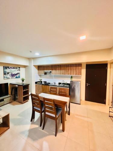 a large kitchen with a table and chairs in it at Avida Towers Atria in Iloilo City