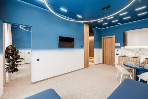 a conference room with blue walls and a table and chairs at Tavel Hotel & SPA in Bukovel