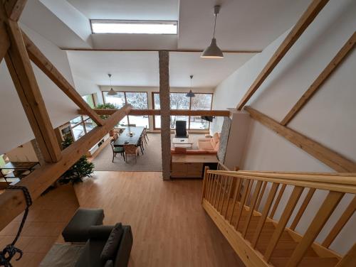 a room with a staircase and a living room at Chalupa Pod Bukovou horou in Smržovka
