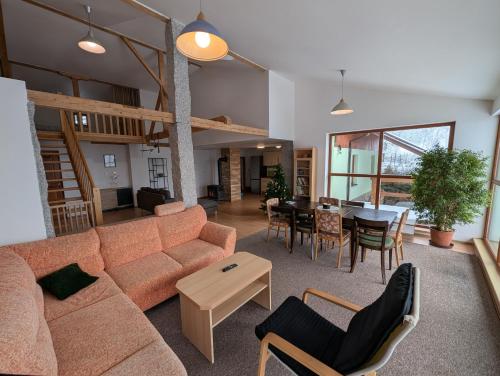a living room with a couch and a table at Chalupa Pod Bukovou horou in Smržovka