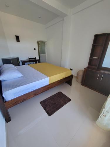 a bedroom with a bed in a white room at captain mirissa in Mirissa