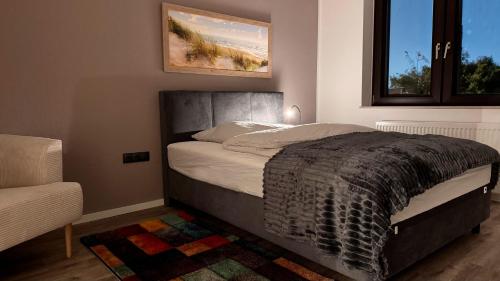 a bedroom with a large bed with a window at Haus Kirijan in Garbsen