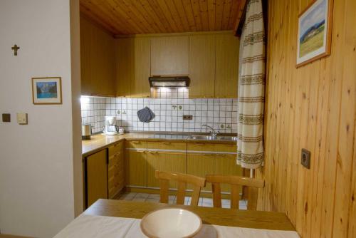a small kitchen with a table and two chairs at Appartement Alpenblick in Valdaora