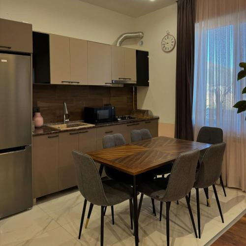a kitchen with a dining room table and chairs at Aparan Guest House in Aparan
