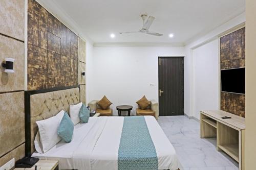 a hotel room with a bed and a tv at HOTEL SHYAM INTERNATIONAL - NEAR TERMINAL 3 DELHI AIRPORT WITH - Free AIRPORT PICKUP in New Delhi