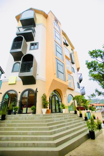 a building with stairs in front of it at QR Hotel Dalat in Xuan An
