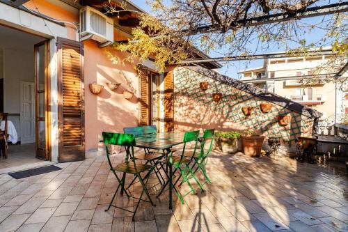 a glass table and chairs on a patio at Le Terrazze di Cesy in Brescia