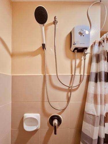 a shower in a bathroom with a blow dryer at Avida Towers Atria in Iloilo City