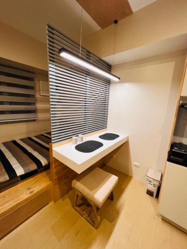 a bedroom with a desk and a bunk bed at Avida Towers Atria in Iloilo City