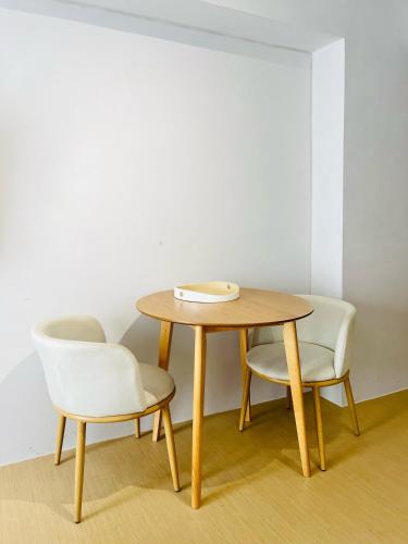 a table and two chairs and a wooden table and chairs at Avida Towers Atria in Iloilo City
