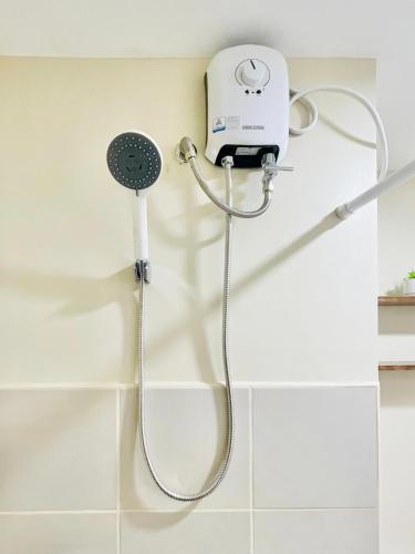 a shower with a blow dryer in a bathroom at Avida Towers Atria in Iloilo City