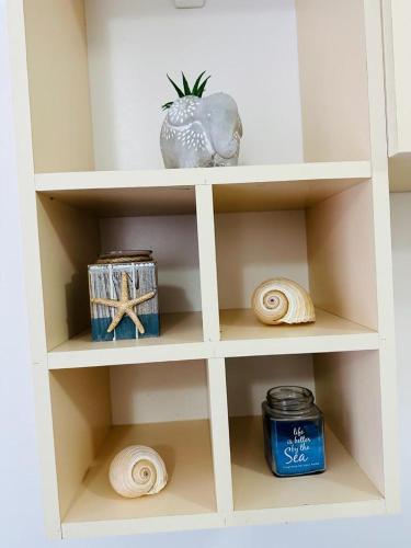 a white shelf withautical items on it at Valamar Apartment Hamallaj in Draçi