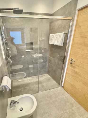 a bathroom with a shower and a sink at Residence Vajolet San Cassiano in San Cassiano