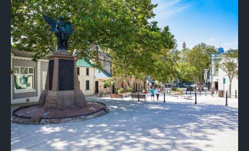 a statue of a woman on a pedestal in a street at Comforting 2BR House & FishMarket & Casino-3 mins walk in Sydney