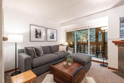 a living room with a couch and a table at Sunpath by Outpost Whistler in Whistler
