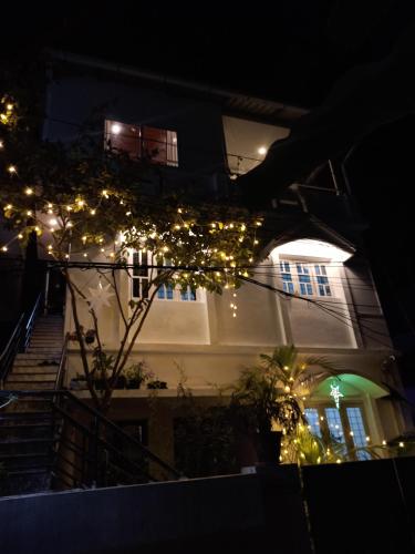 a building with christmas lights in front of it at Bethesda Inn in Cochin