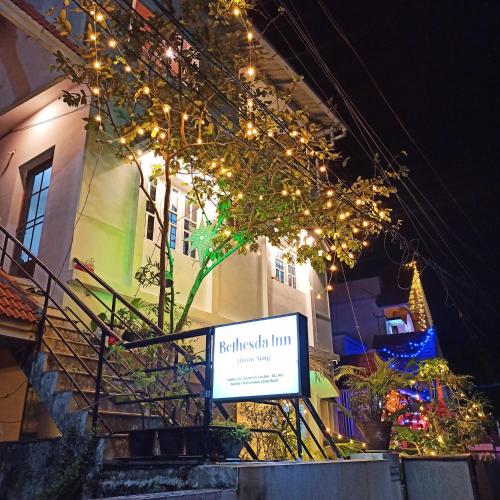 a sign on a building with christmas lights at Bethesda Inn in Cochin