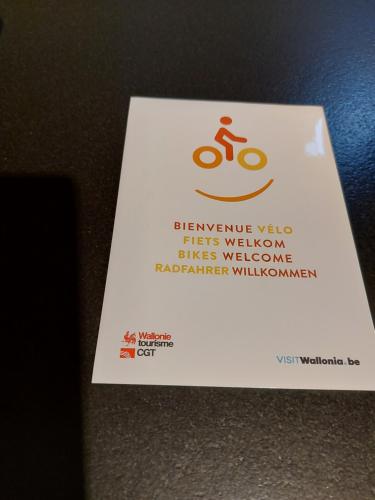 a white card with a bike sign on a table at Gite Evasion in Aywaille