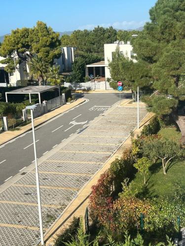 an empty street with a stop sign and trees at Valamar Sea View Apartment in Hamallë