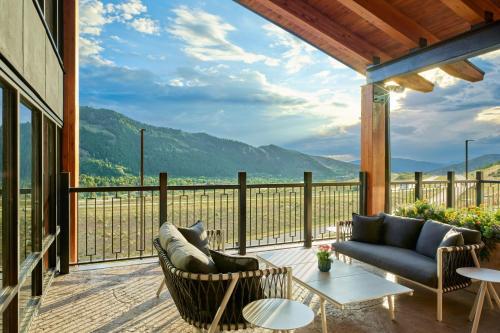a patio with a couch and chairs on a balcony at TownePlace Suites by Marriott Avon Vail Valley in Avon